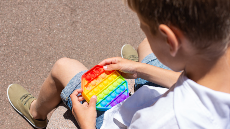 boy playing with a fidget toy outside