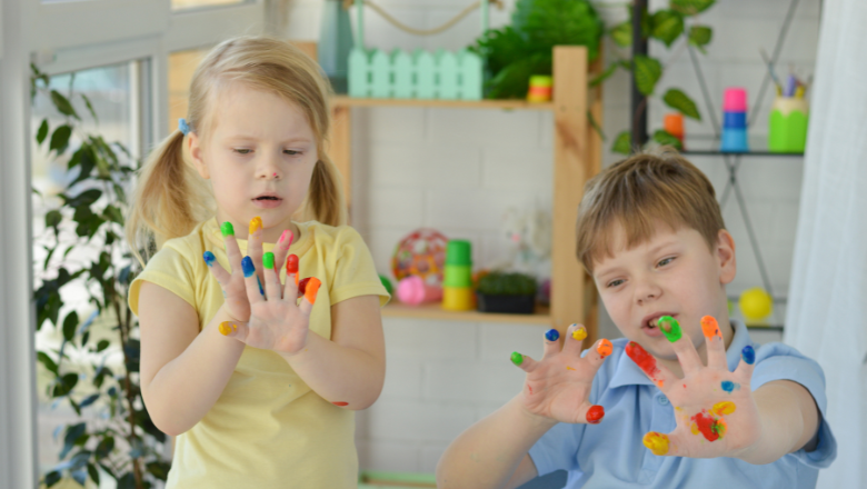 boy and girl playing finger paint